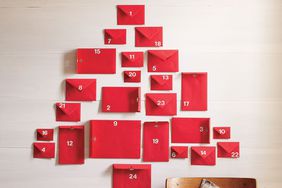 advent calendar on wall made of red envelopes