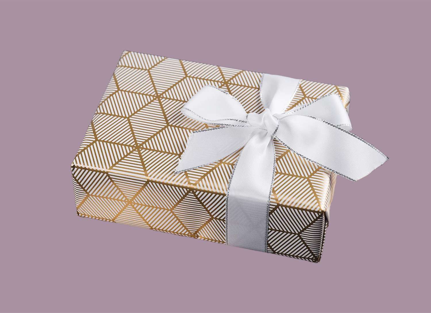 gold patterned gift on purple background