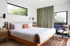 neutral-colored master bedroom with wood accents