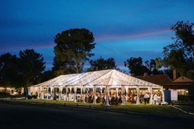 large white reception tent lit with string lights