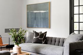 living room with art and a grey sofa