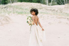 bride wearing backless wedding dress on the beach