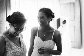 bride laughing with mother on wedding day