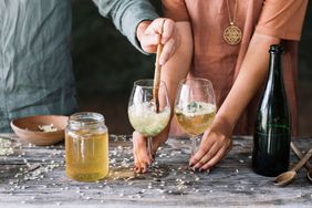 Couple making wine cocktails
