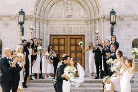 couple kissing on church steps after wedding