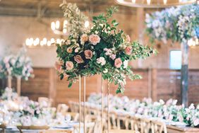 indoor reception round tables with tall floral centerpieces