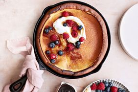 classic dutch baby topped with berries and cream