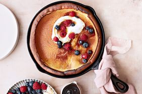 classic dutch baby topped with berries and cream