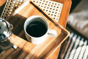white coffee cup on wood serving tray
