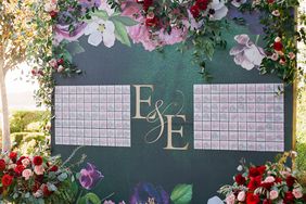 wedding seating chart board surrounded by flowers