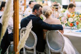 couple embracing at table during wedding reception