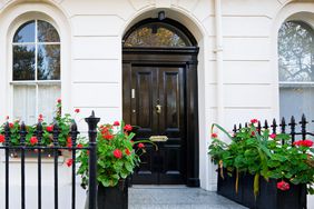 White row house with black door in central London