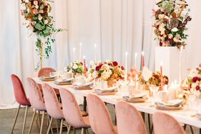 floral arch pink chairs long white table reception decor