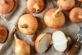 Raw garden onions on linen sackcloth