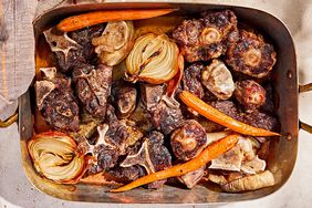 overhead view of beef and carrots in a roasting pan