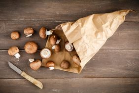 Fresh mushrooms in brown paper bag