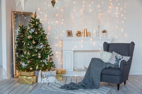 Modern design room in light colors decorated with Christmas tree and decorative elements