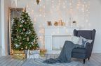 Modern design room in light colors decorated with Christmas tree and decorative elements