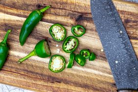 sliced jalapenos on wood cutting board