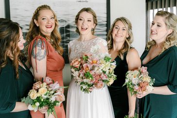 bridesmaids in coral and deep green dresses