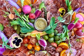 close up of a colorful charcuterie board with flowers