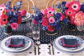 Colorful table setting with pink and purple flowers