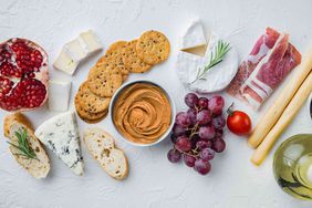 Nut butter and charcuterie ingredients on white background