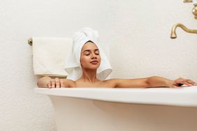 Woman soaking in oatmeal bath