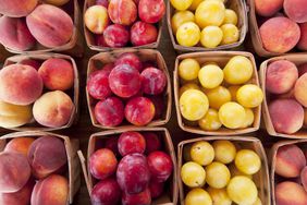 Ripe peaches and plums for sale at a farmers market