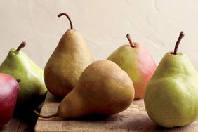 Variety of pears on wooden surface