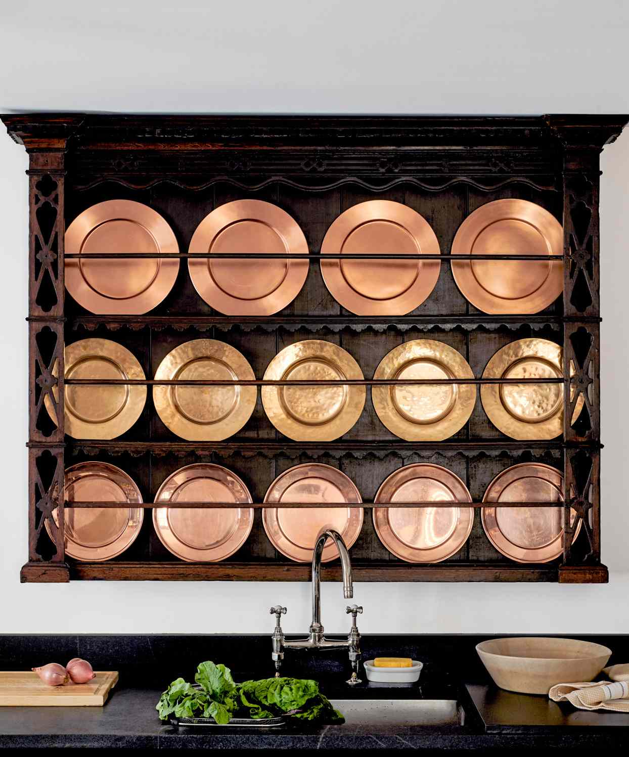 plate rack with antique copper dishes