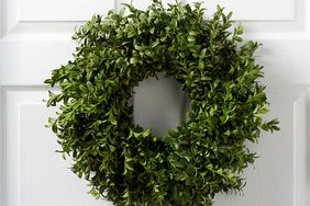 fresh boxwood wreath on white door