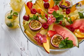 A punch bowl filled with a fruit display