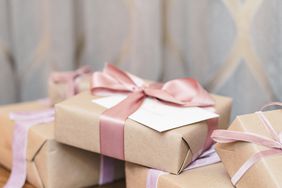 reception gifts in brown wrapping with pink and purple ribbon bows