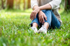 Sitting in grass with jeans 