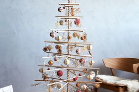 scandinavian christmas tree with wooden ornaments in living room