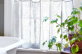 tea towel curtains hanging in bright window