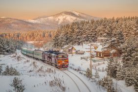 Train traveling through wintry city