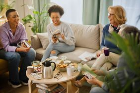 Small group of people with a mixed age range talking during a book club meeting.