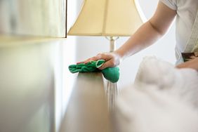 Young woman cleaning surfaces with green cleaning products