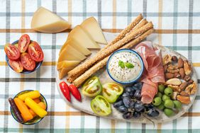 Simple charcuterie board with cheese, vegetables and nuts