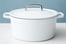white dutch oven on a white and blue background