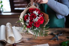 Florist wrapping Red Roses for Valentine's Day