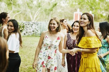 wedding guests wearing floral and colorful dresses